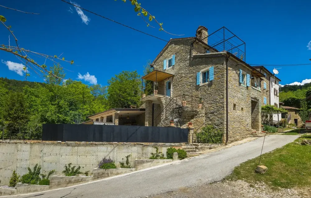 Stone house with blue shutters in countryside