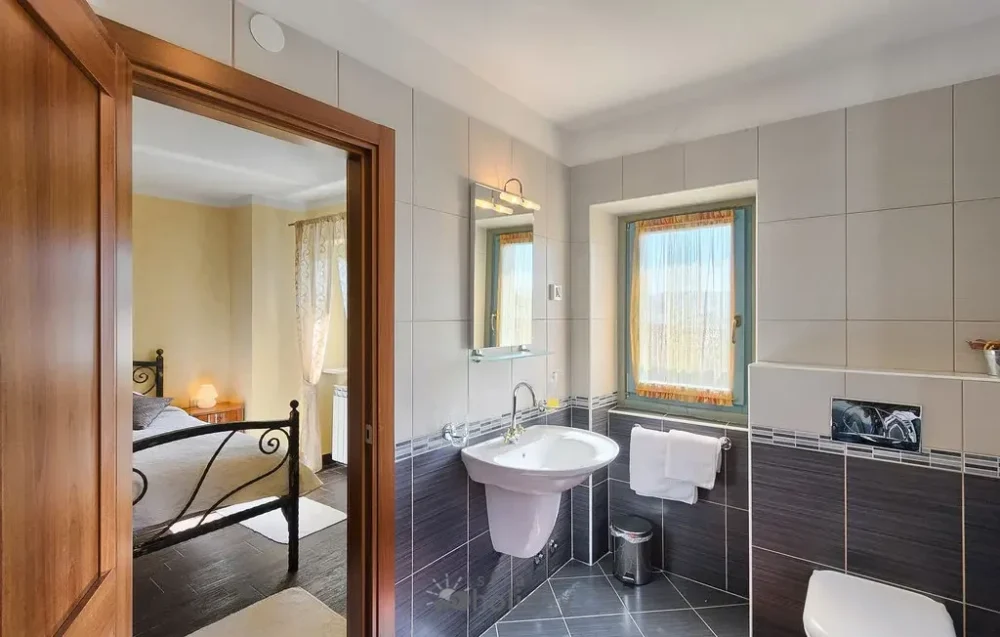 Modern bathroom with view of a bedroom