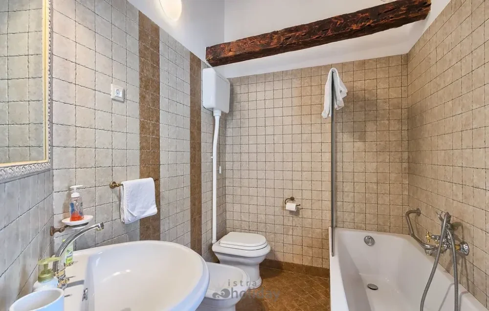 Modern bathroom with sink, toilet, and bathtub
