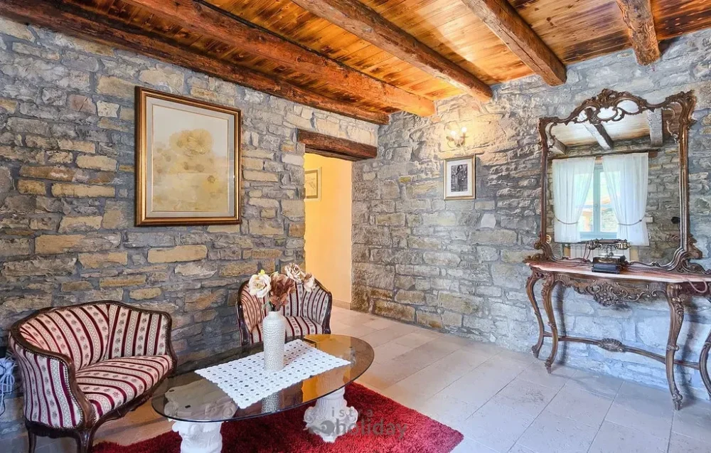 Cozy rustic living room with stone walls.