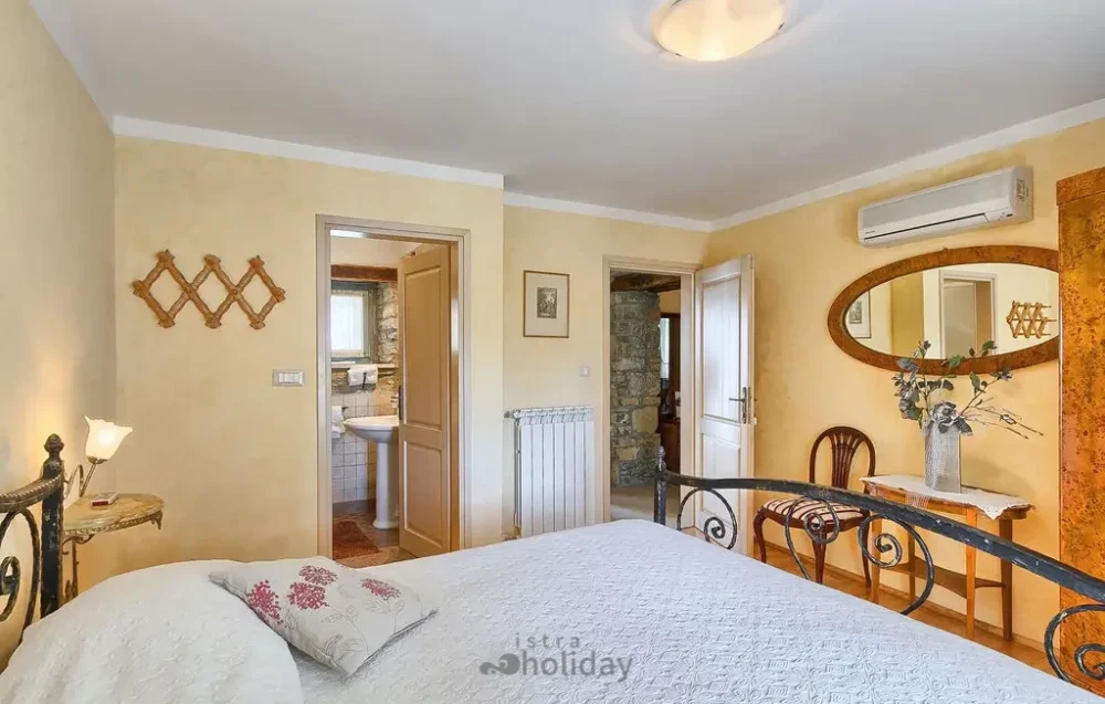 Cozy bedroom with elegant decor and wooden furniture.