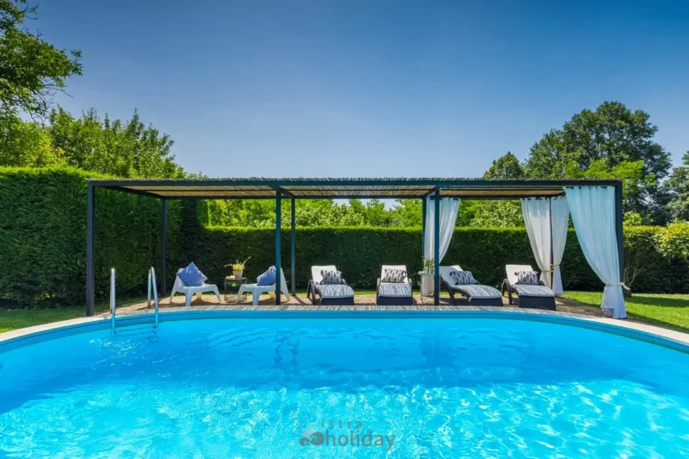 Outdoor pool with lounge chairs and canopy