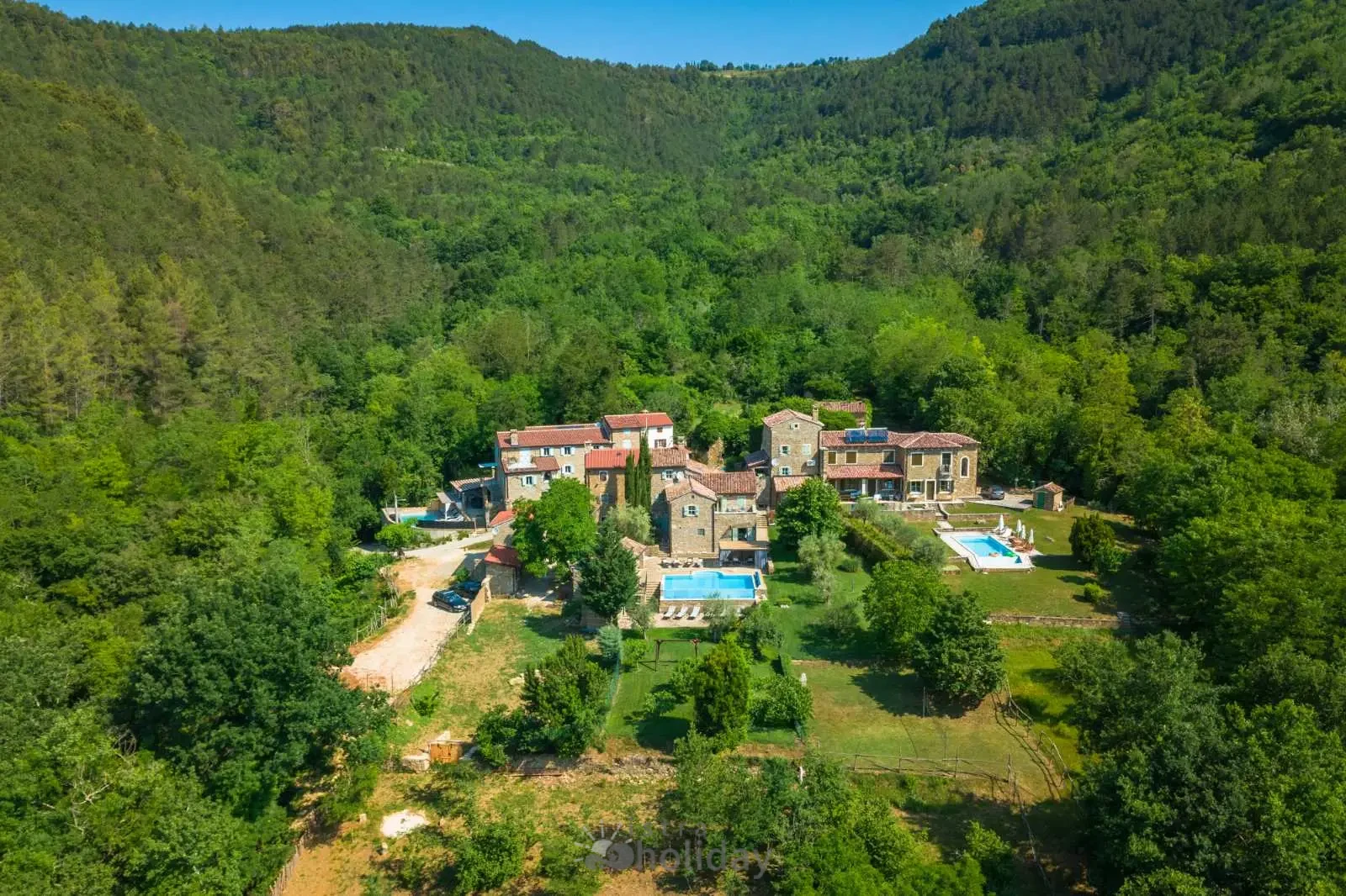 Aerial view of secluded countryside villas in nature.