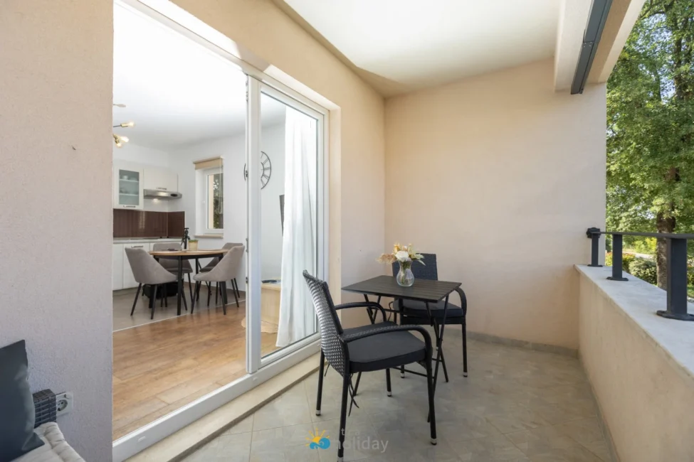 Small balcony with table and sliding glass door