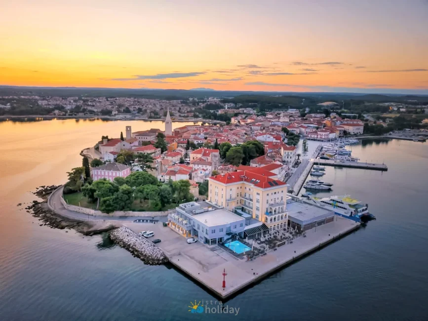 Aerial view of coastal town and marina at sunset