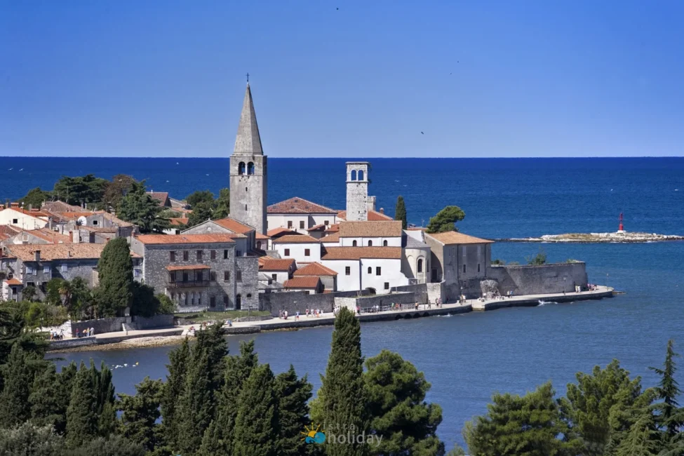 Historic coastal town with church towers and blue sea