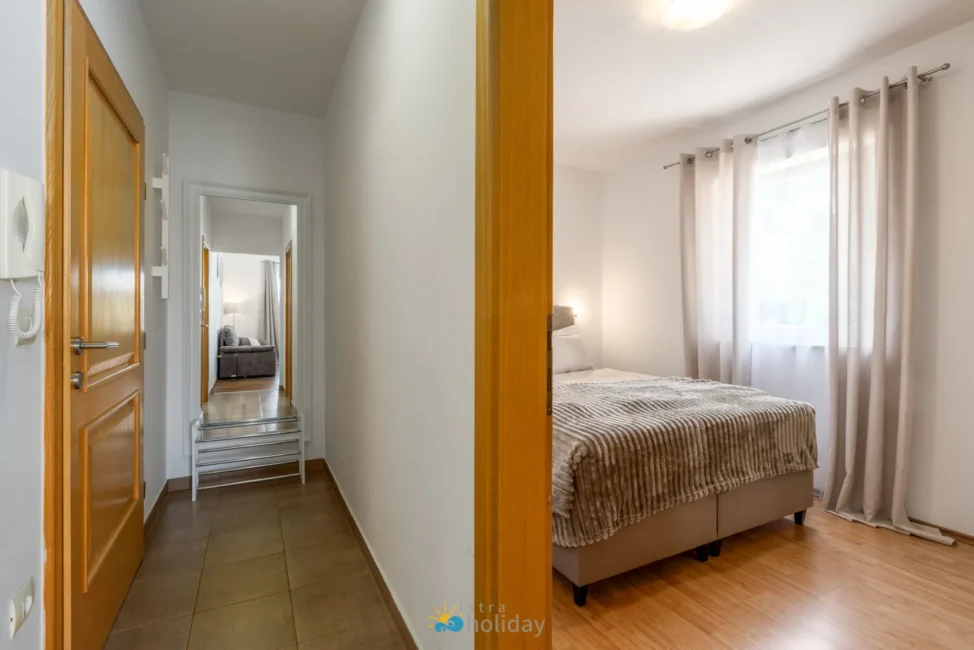 Modern bedroom and hallway with wooden floors