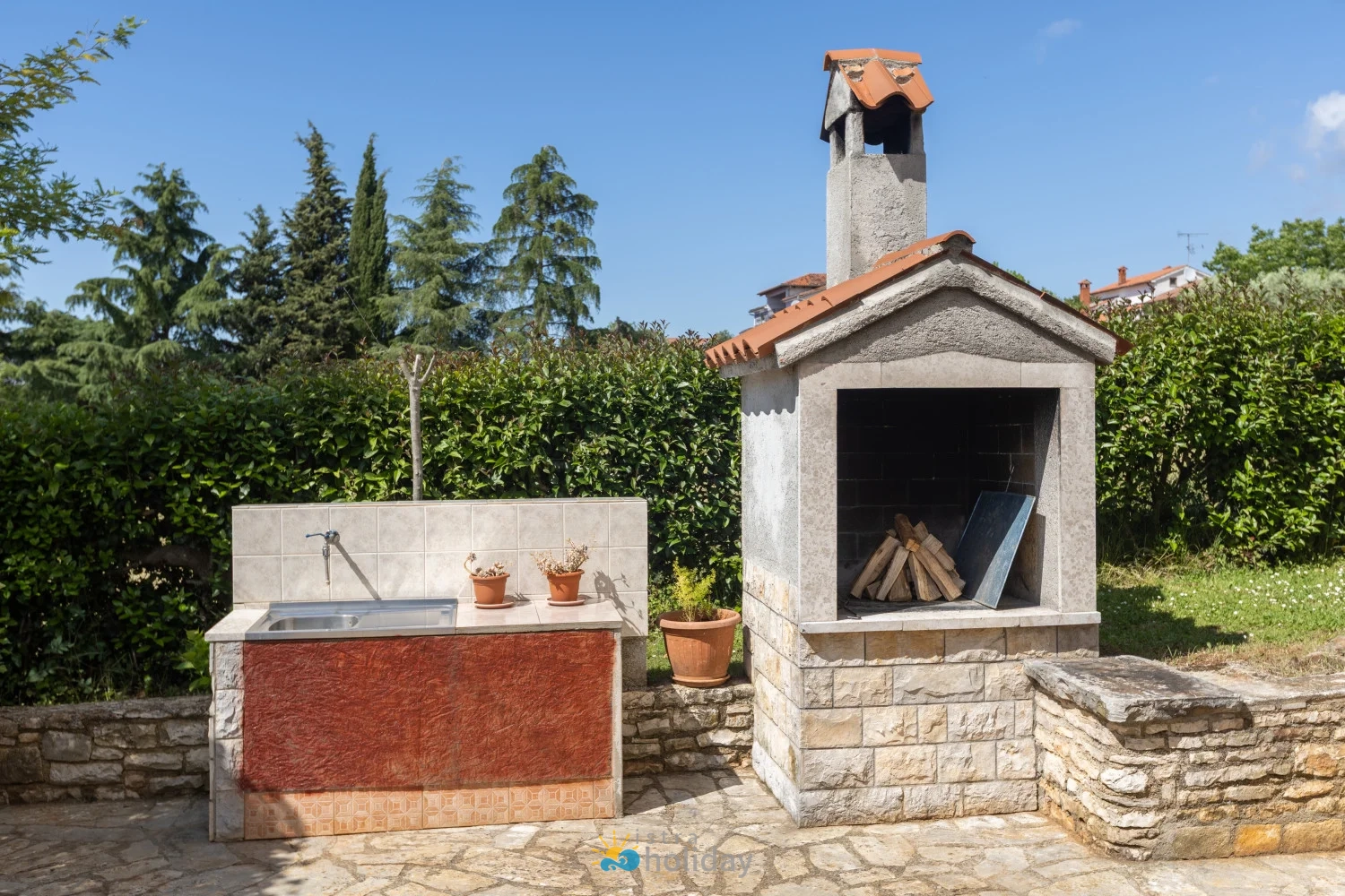 Outdoor stone barbecue grill and garden sink