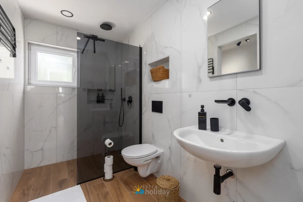 Modern bathroom with glass shower and marble tiles