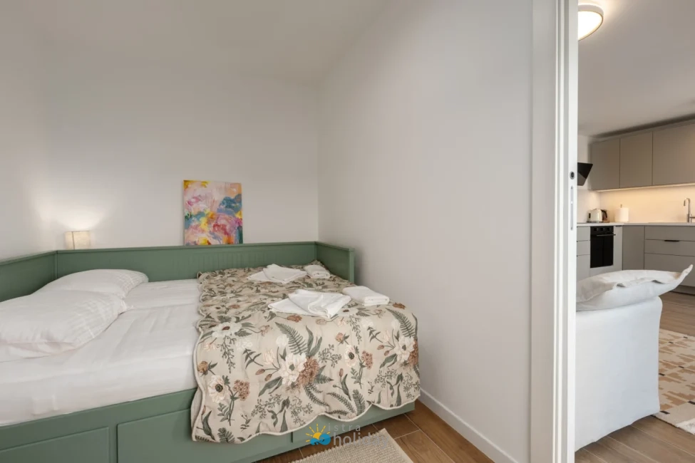 Cozy bedroom with green bed and floral bedding