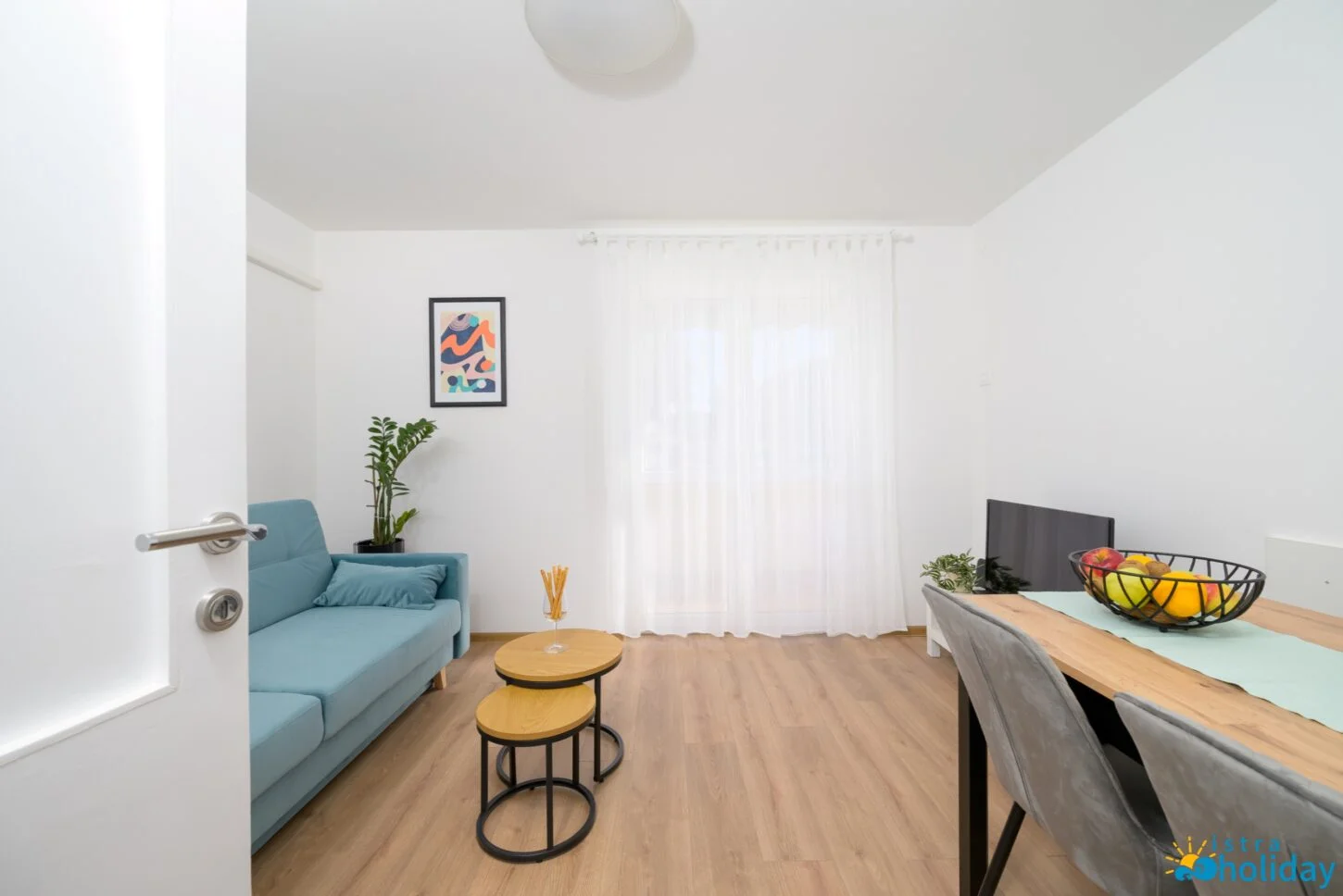 Modern living room with blue sofa and artwork