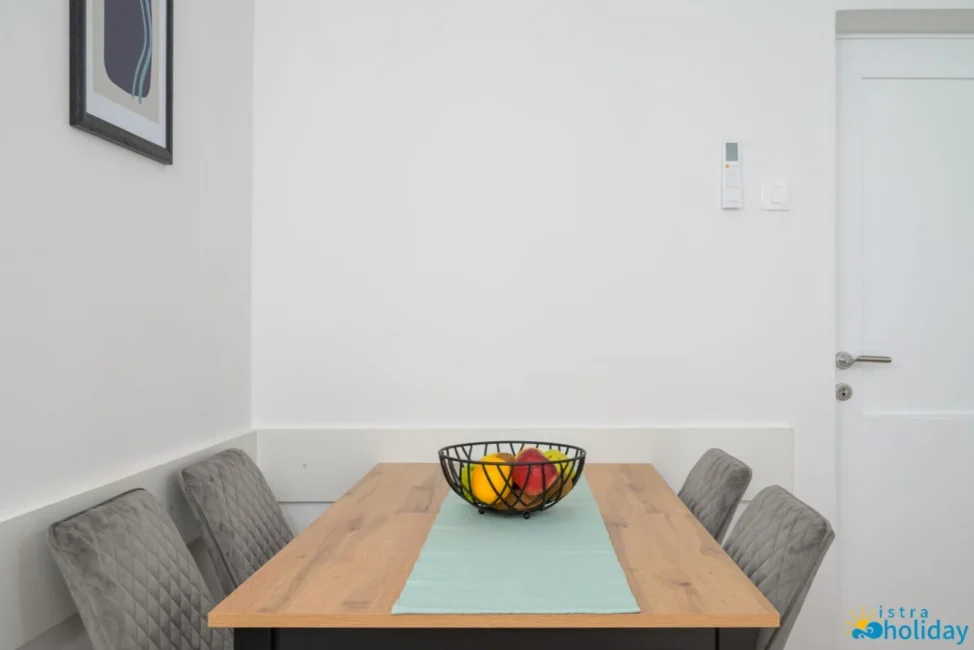 Dining table with fruit basket in modern room.