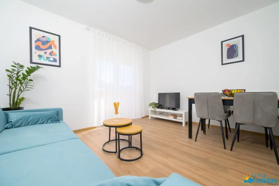 Modern living room with couch and dining area.