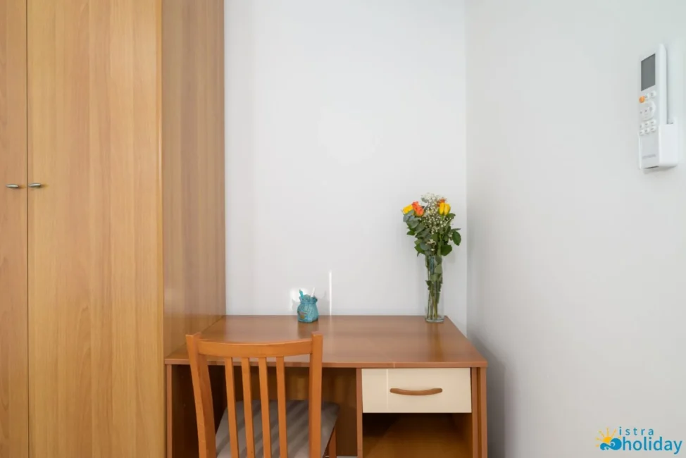 Desk with flowers and chair in corner