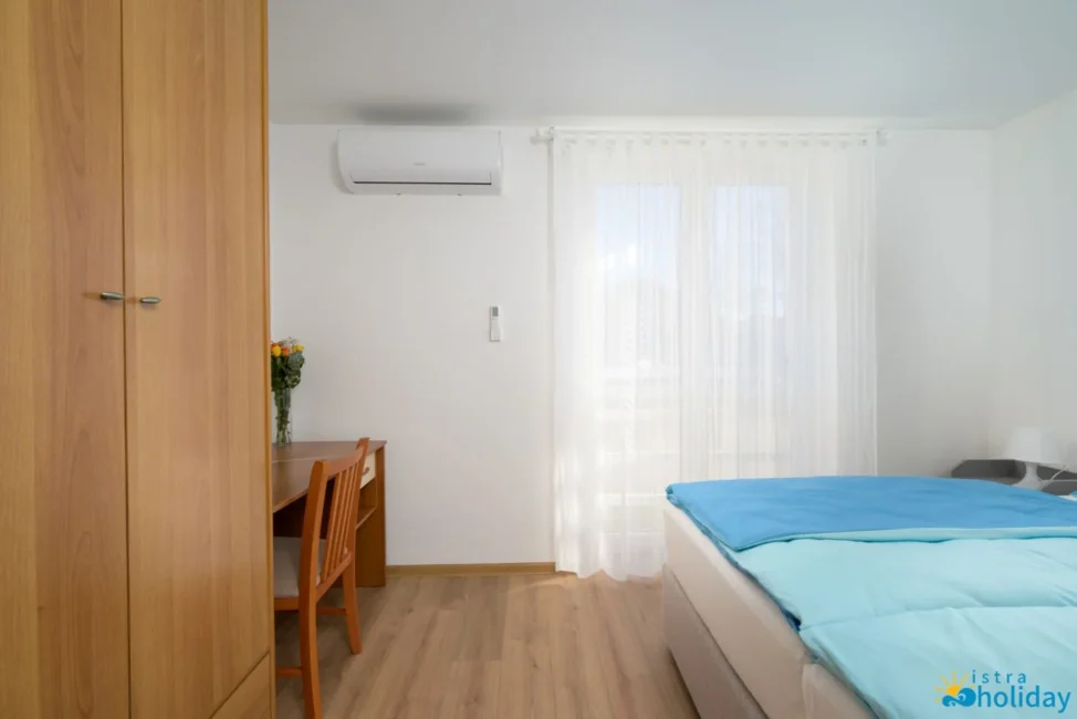 Bright bedroom with desk and wardrobe