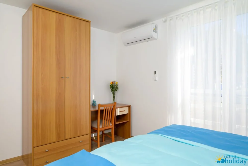 Bright bedroom with wardrobe and desk.