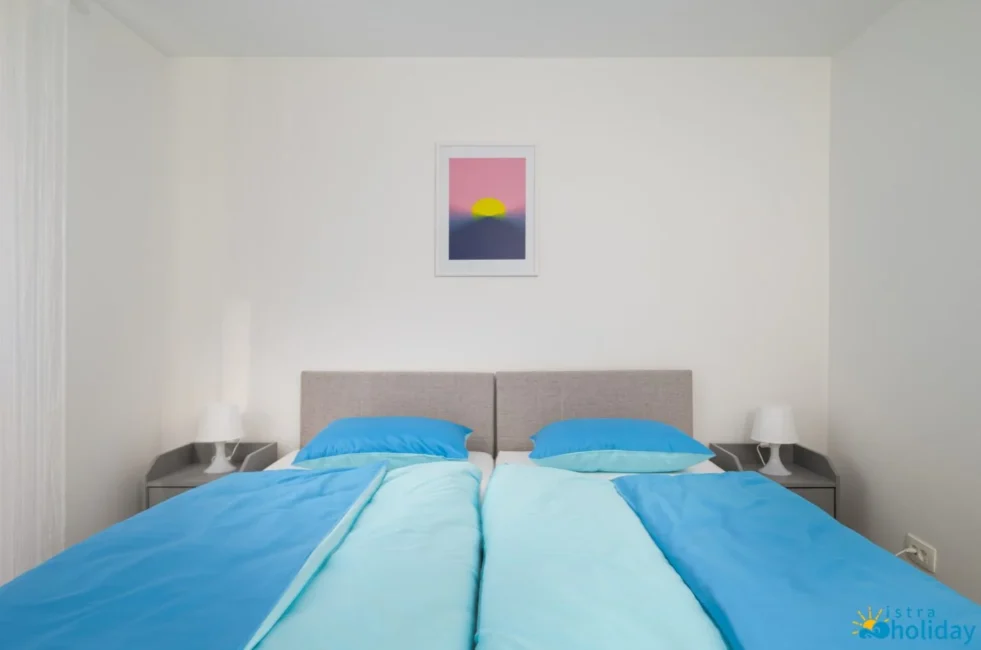 Modern bedroom with blue bedding and artwork