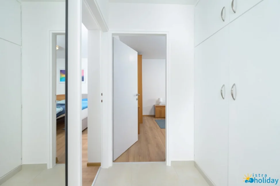 Open doorway leading to a bright bedroom