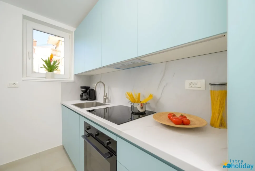 Modern kitchen with blue cabinets and cookware