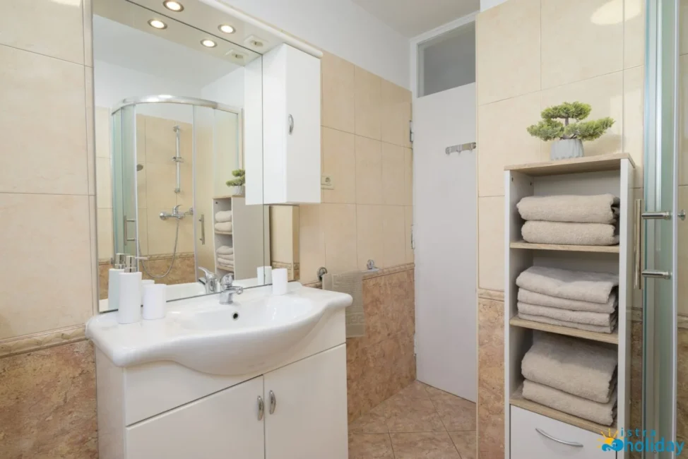 Modern bathroom with shower and white cabinets.