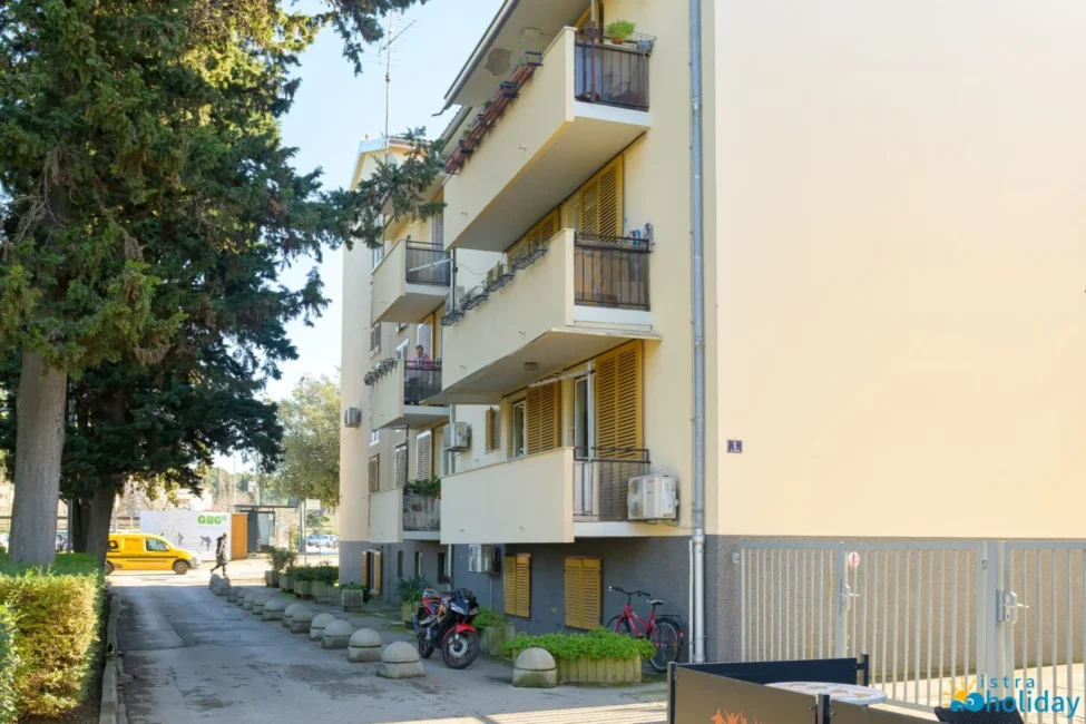 Apartment building with balconies and parked bicycles.