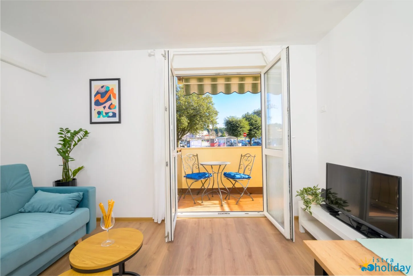 Cozy living room with balcony and outdoor seating.