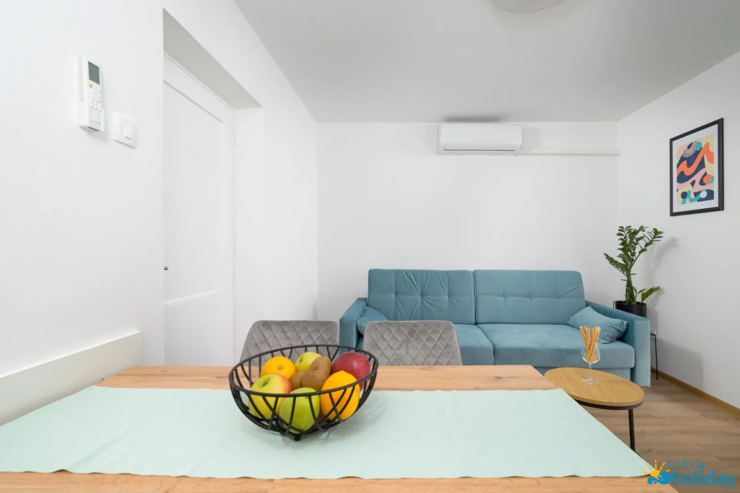 Modern living room with sofa and fruit bowl.