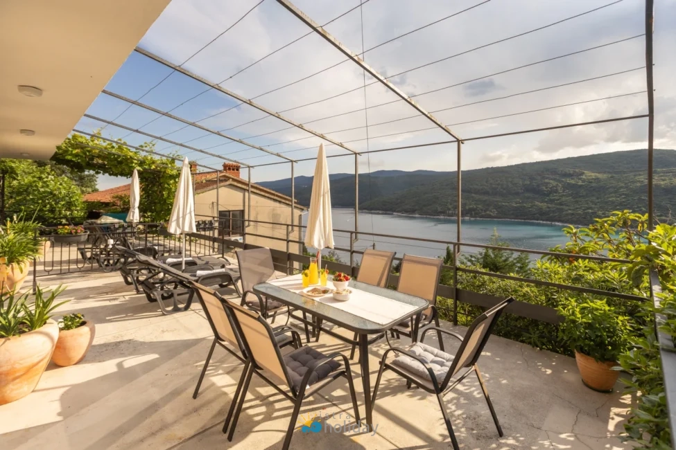 Terrace patio overlooking bay and green hills