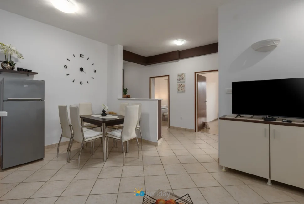 Modern dining area with TV and refrigerator