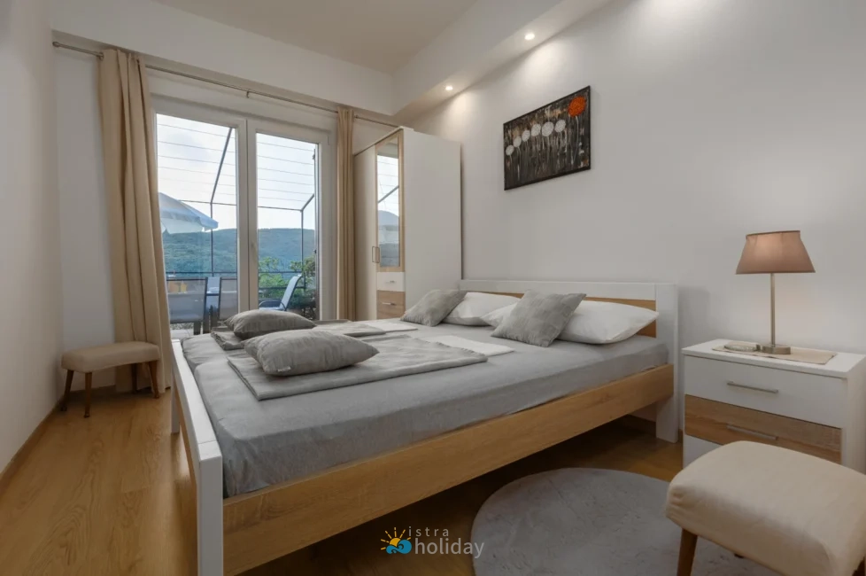 Modern bedroom with balcony and mountain view
