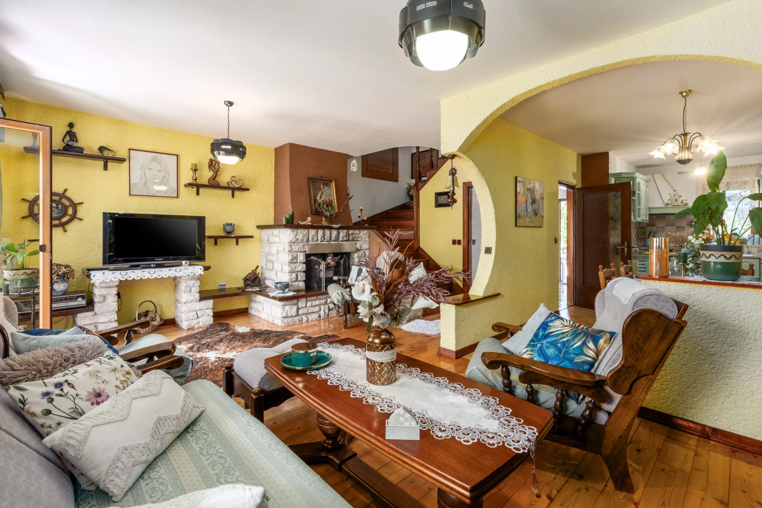 Cozy living room with stone fireplace and wooden furniture