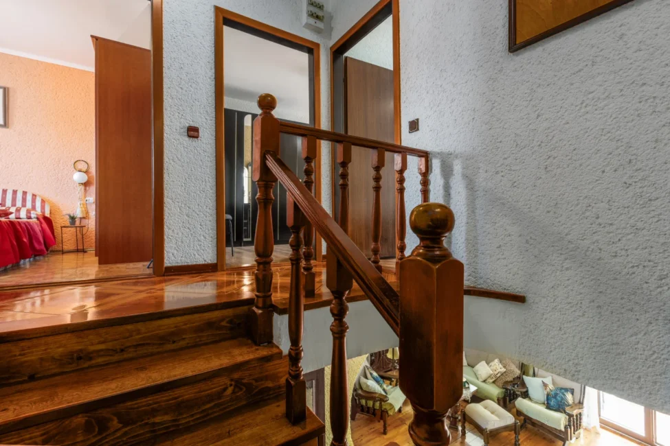 Wooden staircase with banister in cozy home interior