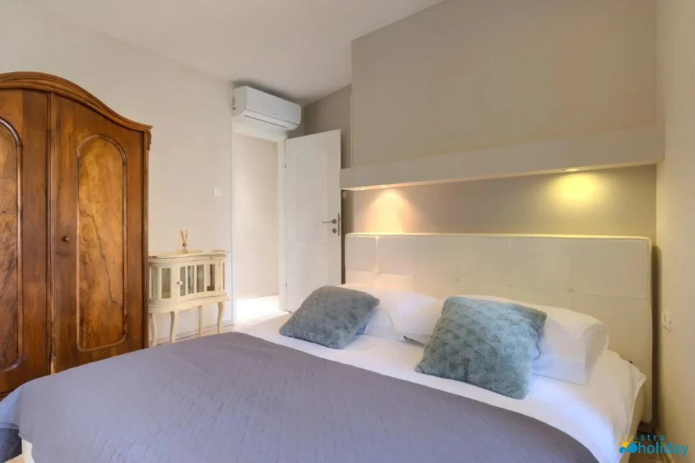 Cozy bedroom with wooden wardrobe and soft lighting