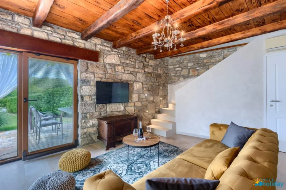Cozy rustic living room with stone walls and sofa.