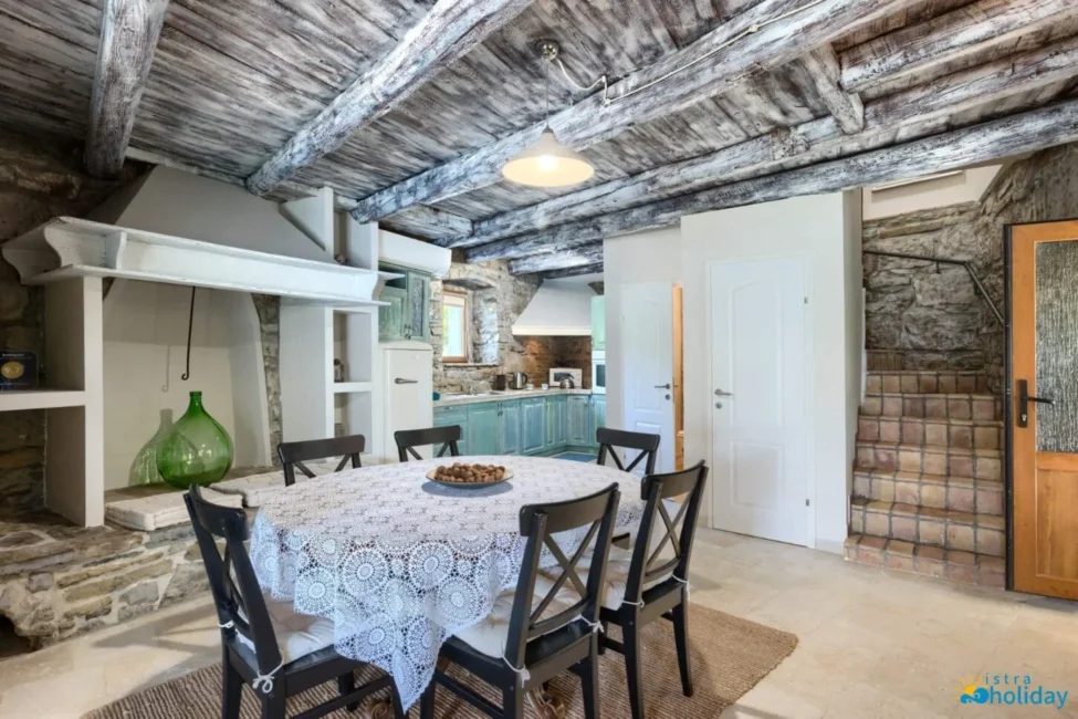 Rustic kitchen with wooden ceiling and dining table