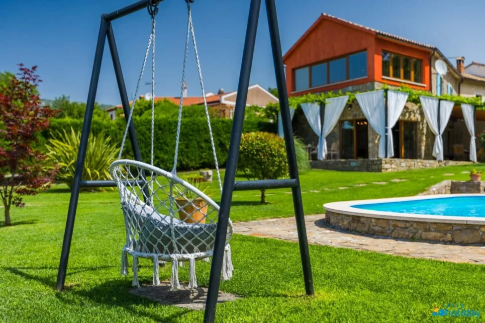 Sunny backyard with swing and pool