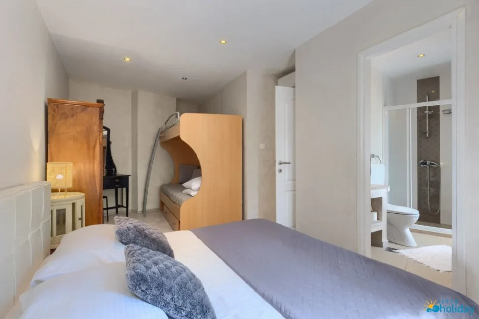 Cozy bedroom with bunk beds and bathroom.