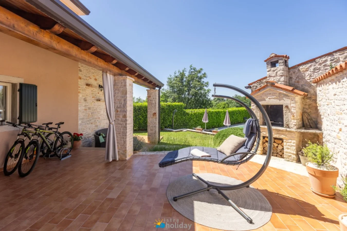 Sunny stone patio with hanging lounge chair