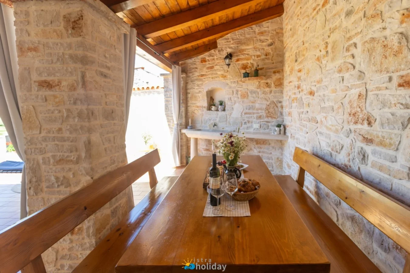 Rustic stone patio with wooden dining table