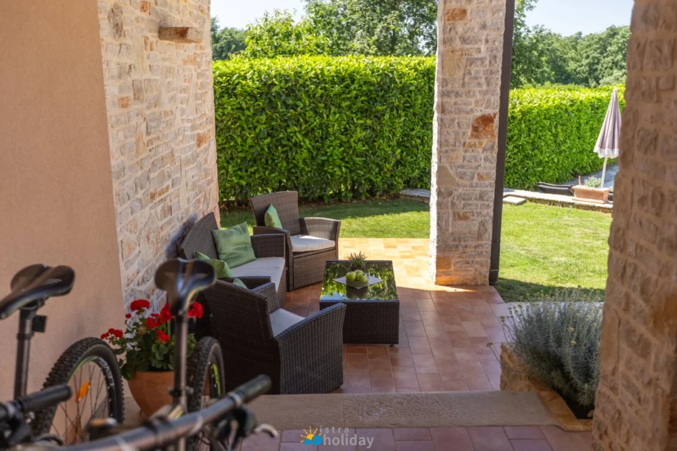 Covered patio with wicker seating and garden view