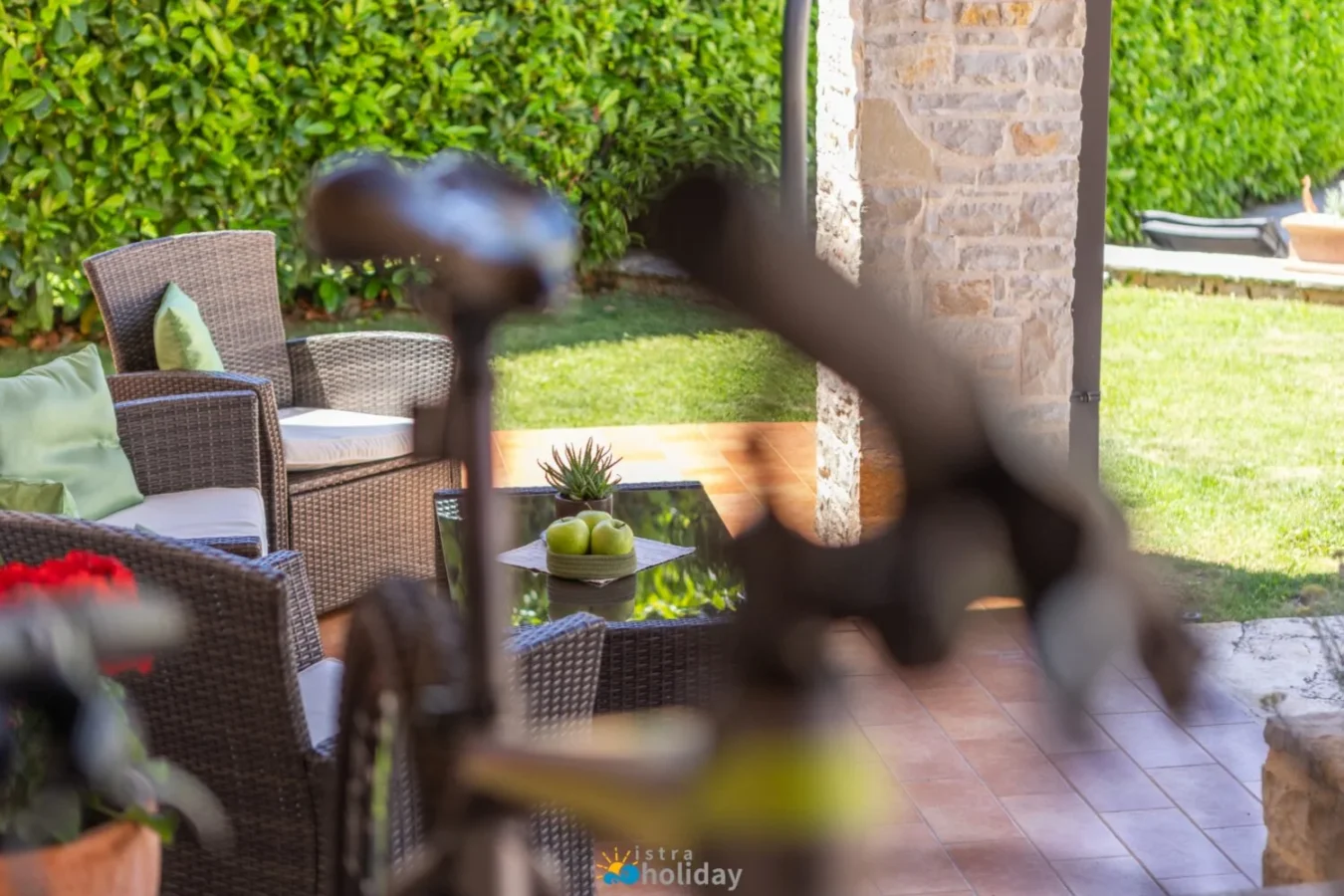 Cozy outdoor patio with wicker furniture and garden
