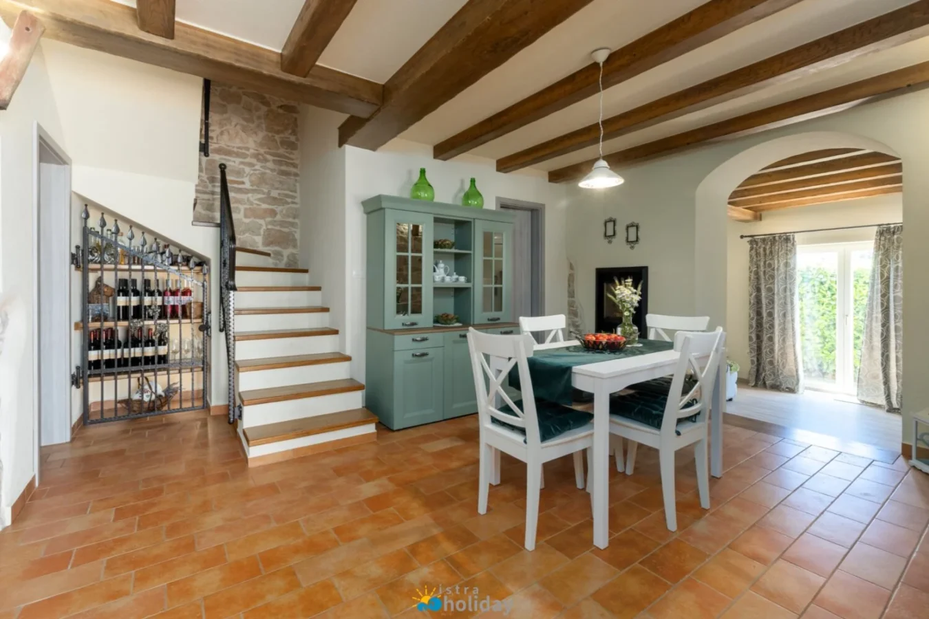 Rustic dining room with wooden beams and staircase