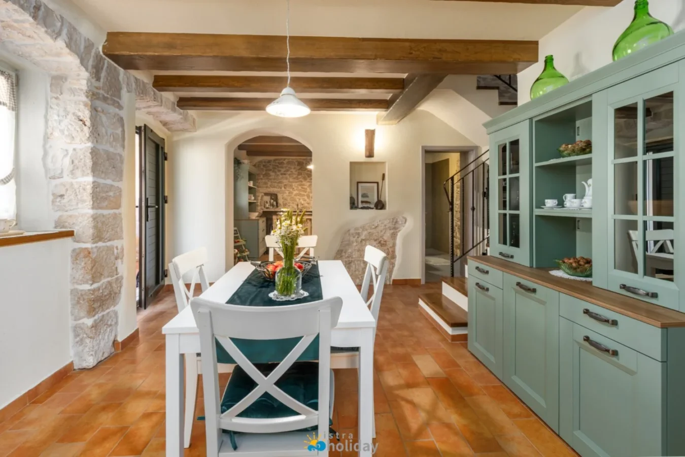 Rustic dining room with wooden beams and stone walls