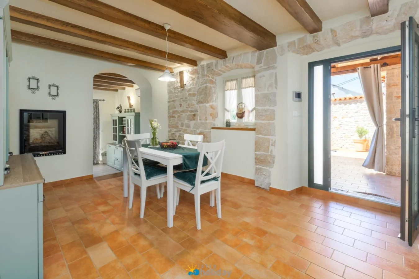 Rustic dining room with stone walls and beams