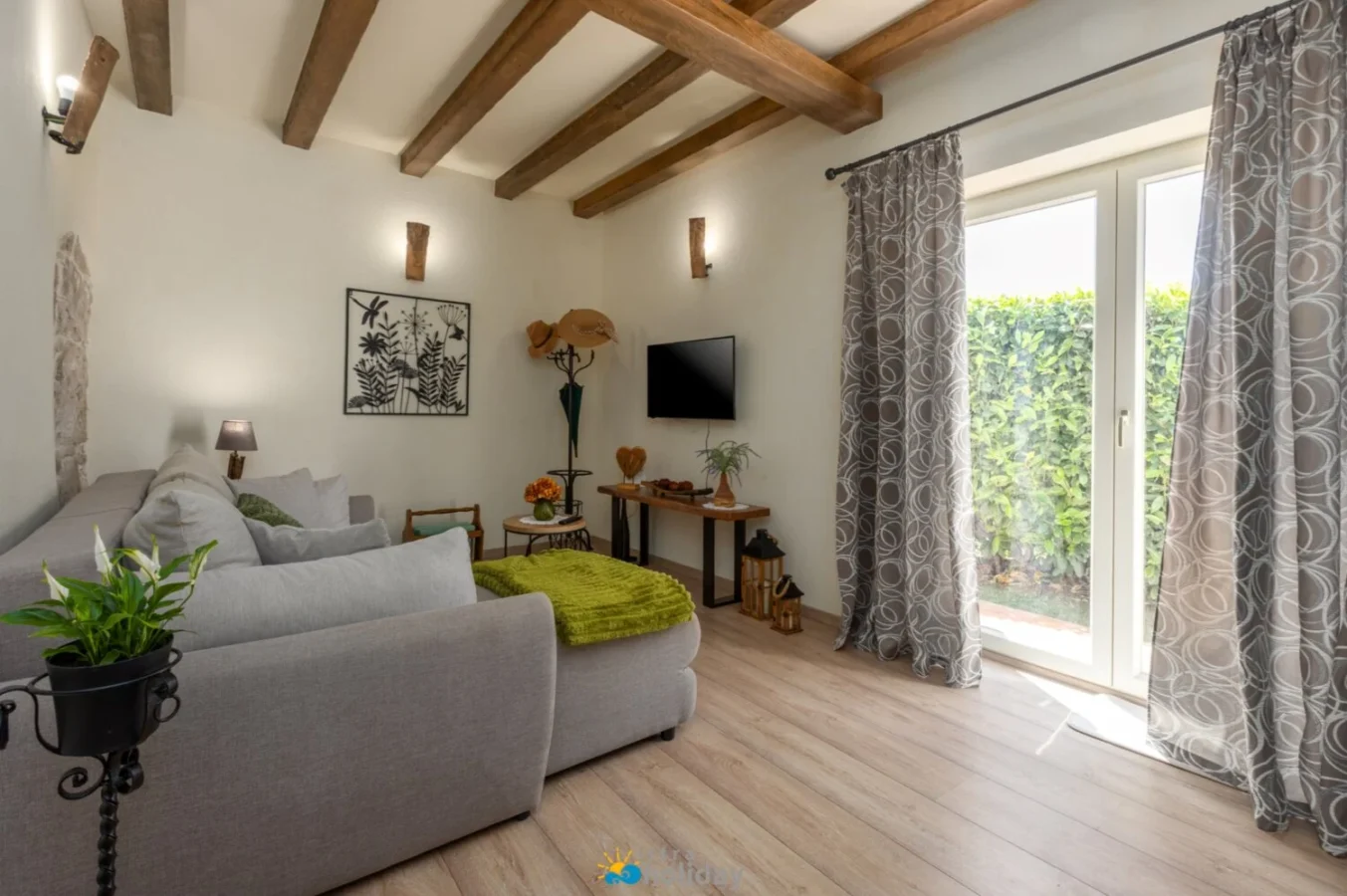 Cozy living room with wooden beams and patio doors