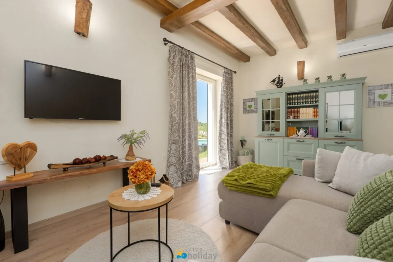 Cozy living room with beams and green accents
