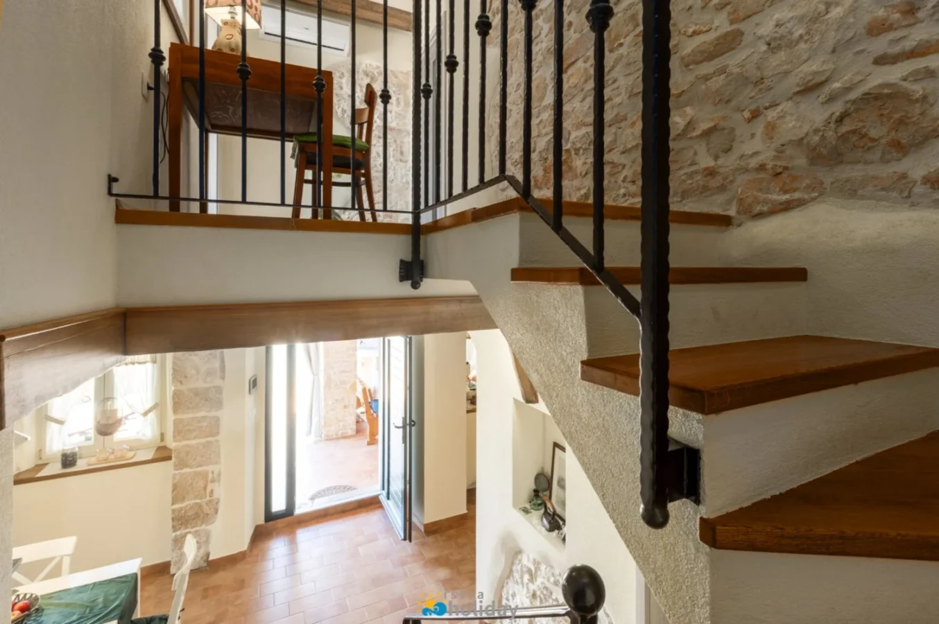 Rustic interior with wooden staircase and stone walls