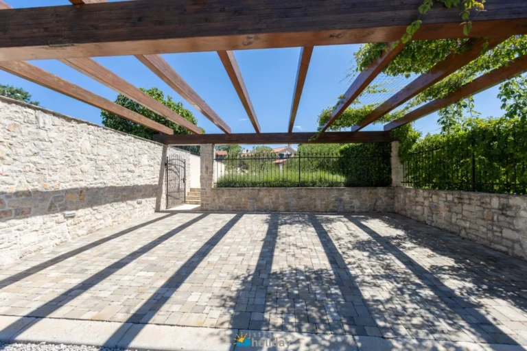 Stone courtyard with wooden pergola and gate