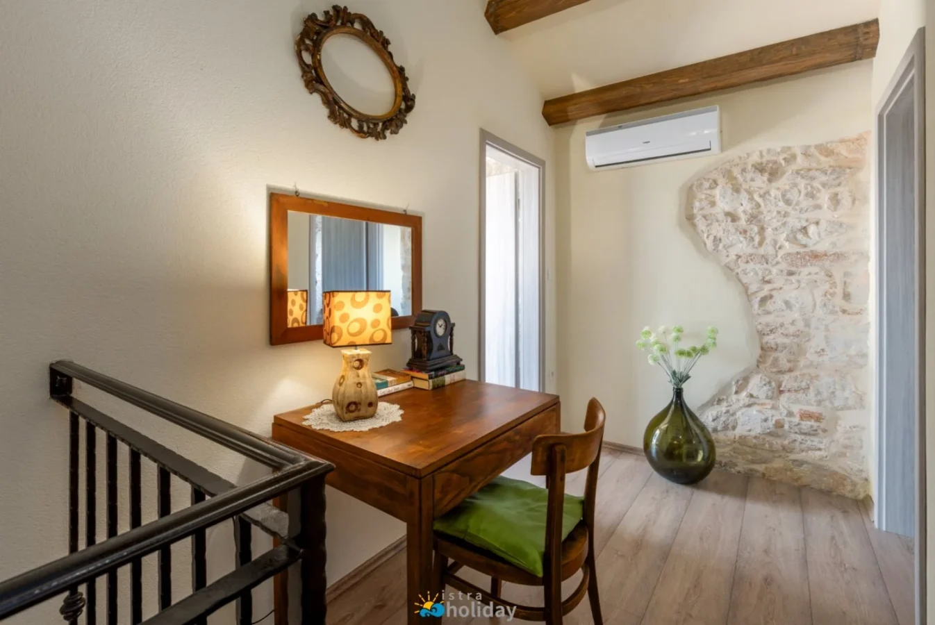 Rustic wooden desk beside exposed stone wall