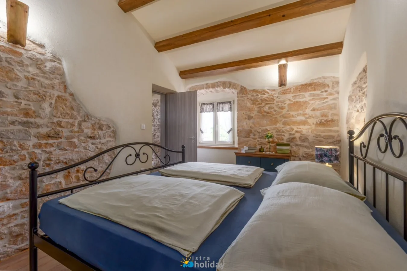 Rustic bedroom with stone walls and beams